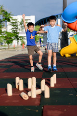 Young asian boy play with wooden toy number