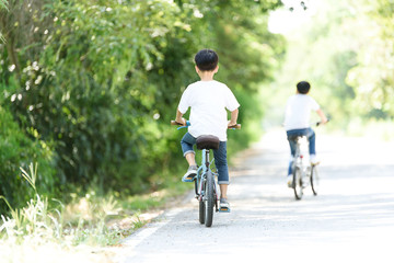 Obraz premium Young boy ride bicycle