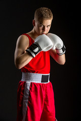 Fototapeta na wymiar Young boxer sportsman in red sport suit