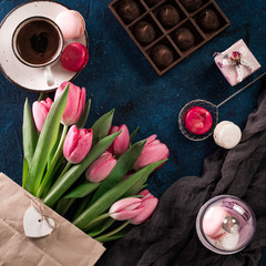 romantic breakfast Cappuccino ,strawberry macaroons, pink tulips, gift box on blue table.Valentine's day concept