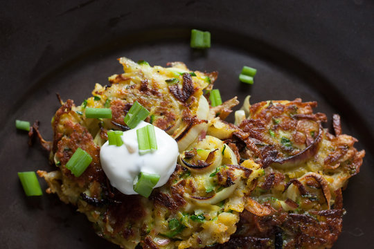 Potato Zucchini Latkes With Green Onion And A Dollop Of Sour Cream