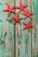 Shell and starfish frame with space on wooden old background. Summer holiday concept