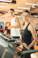 Young woman working out in a treadmill at the gym.