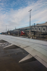 View of an airport and wing of an aircraft