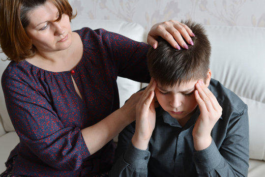 mother cares for her son who has headache