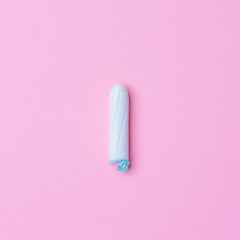 Menstrual tampon isolated on a pink background. Menstruation time. Hygiene and protection. Pasterl colors