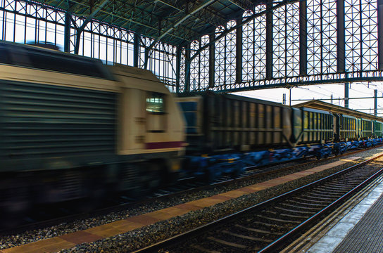freight train speeding through train station