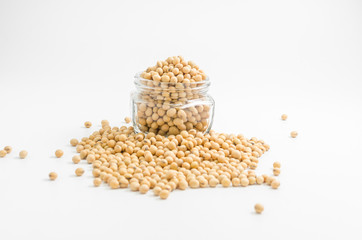 soybeans in glass jar on white background..