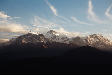 Amazing cloudy sunrise in the Himalayas with snow on peaks. Calm and peaceful shot of beautiful high mountains, perfect destination for mountaineer. Hiking, climbing and mountaineering concept