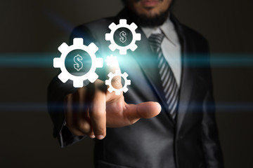 Businessman touching technology interface with gear.