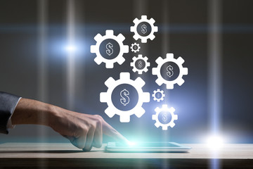 Businessman touching technology laptop with gear wheel setting.