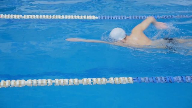 Men and women are training in the pool. Slow motion