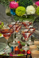 glasses with straws on the background of flowers