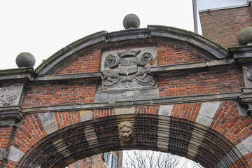 Ancient arch with heraldic sign on it in historic centre of Utre