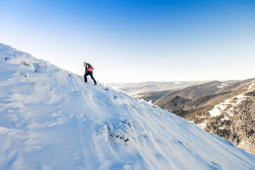 A male mountaineer walking uphill on a glacier. Mountaineer reac