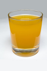 Glass with yellow liquid
