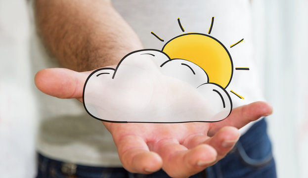 Man holding hand drawn cloud and sun icons