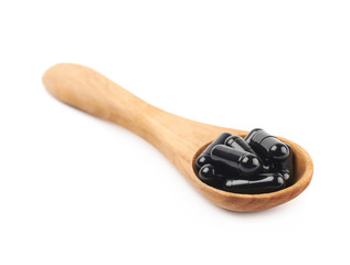 Spoon full of capsule pills isolated