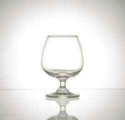 Closeup shot of empty crystal wine glass in retro style.