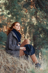 woman with red curly hair outdoors