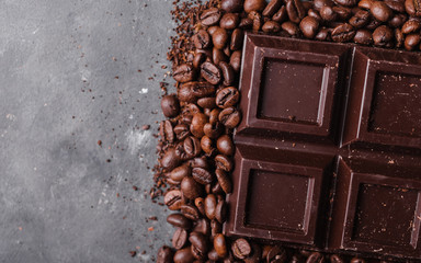 Chocolate and coffee beans .Dark chocolate background. A large bar of chocolate on gray abstract...