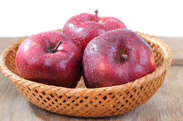 fresh red apples in wicker basket