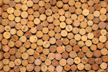 Background of used wine corks. Wall of many different wine corks. Closeup of wine corks.
