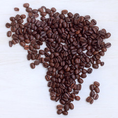 Afrikaans origin present/ coffee beans collected on the table in the shape maps continent, a top view 