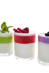 Three Panna cotta with mint, red currant and blackberry