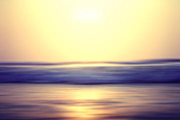 Naklejka na ściany i meble blurred background sunset on the sea