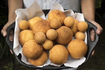 tray in hands - almojabanas and buñuelos - traditional bakery from Colombia