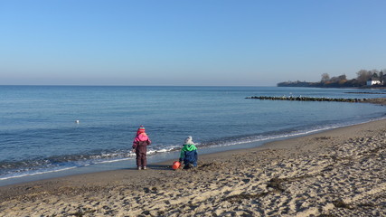 Two children on a sunny winter day at the beach