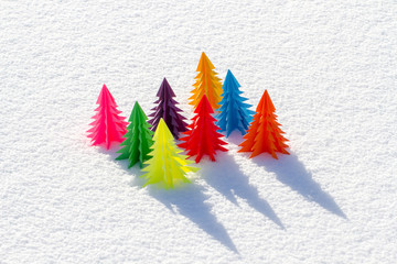 Colorful Christmas tree out of paper in the snow.