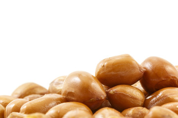 close up of roasted peanuts on white background