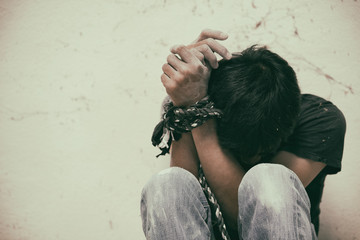 hopeless man hands tied together with rope