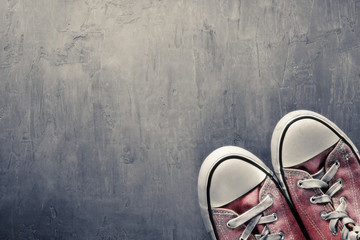 Two red sneaker on  clean concrete background