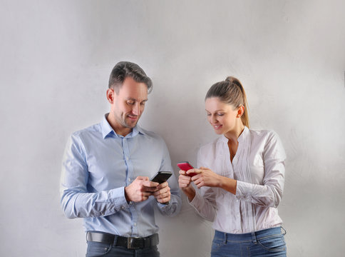 Man and woman changing phone numbers 