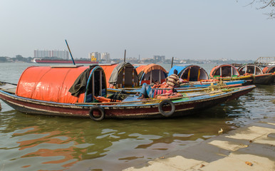 Fototapeta na wymiar Wooden countryside boats are lined up at the Hooghly river bank.