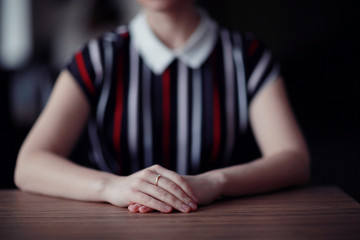 female hands sitting at the table waiting