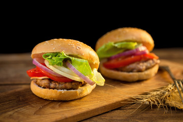 Cheese burger with grilled meat, cheese, tomato, on craft paper