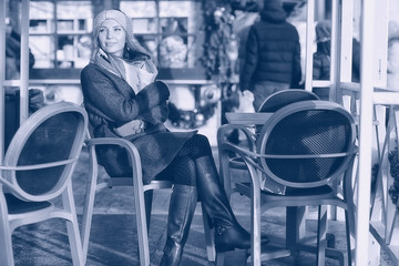 woman on a bench in a winter city