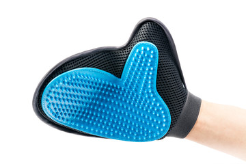 New mitten brush for animals care, dressed on human hand. Isolated on white background