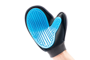 New mitten brush for animals care, dressed on human hand. Isolated on white background