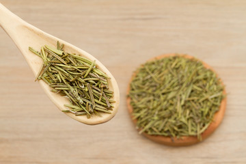 Rosemary medicinal and aromatic plant on wooden background (Rosmarinus officinalis)