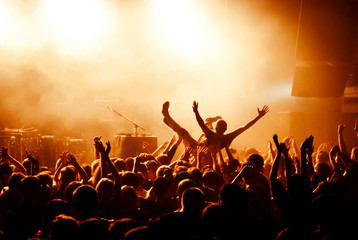 Crowd surfing during at concert - obrazy, fototapety, plakaty