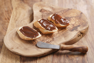 baguette slices with homemade hazelnut cream gianduja on cutting board
