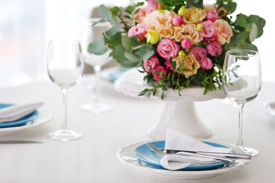 Elegant table setting with beautiful flowers, closeup