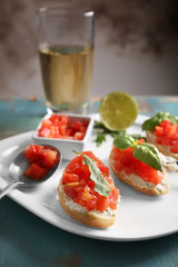 Plate with traditional Italian bruschetta on table