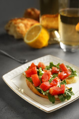 Plate with traditional Italian bruschetta on table