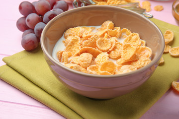 Tasty cornflakes on pink background
